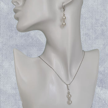 white pearl pendant and earrings